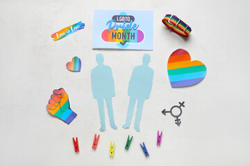 Card with text LGBTQ PRIDE MONTH, paper male figures and symbols on white background