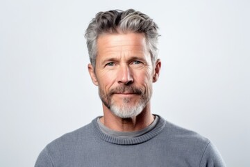 Portrait of handsome mature man with grey hair and beard looking at camera