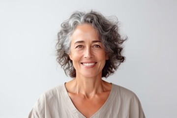 Fototapeta premium Portrait of smiling mature woman with grey hair looking at camera.