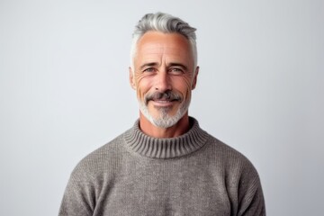 Obraz premium Portrait of a handsome senior man with grey hair against white background