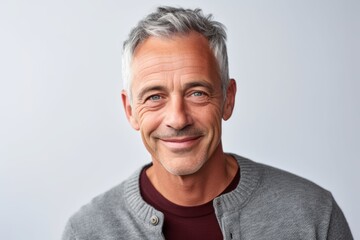 Portrait of a smiling mature man looking at camera isolated on a white background