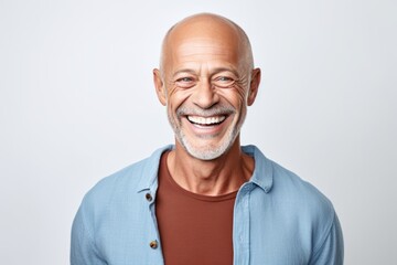 Portrait of happy senior man laughing and looking at camera isolated over white background