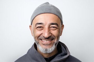 Portrait of a smiling middle-aged man in a gray cap on a white background