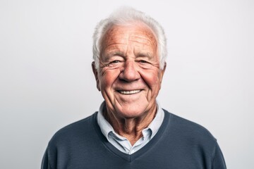Portrait of a senior man smiling at the camera on a white background