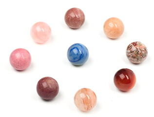 A lone blue marble surrounded by a ring of multi-tonal red marbles.