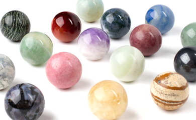 A group of multi-colored, polished marbles, all mixed together, and arranged in an offset grid.