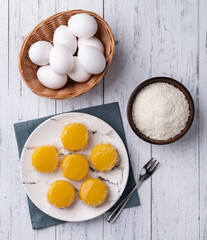 Quindim, traditional egg and coconut brazilian dessert with ingredients