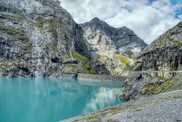 View of the Limmernsee dam in the canton of Glarus. Hiking high above the mountain lake in the...