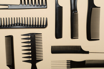 Professional combs and hairdresser tools on color background, top view