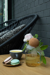 Almond cookies macaroons with a cup of buckwheat tea on a table in an outdoor cafe. Sweet food Still life