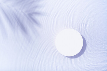 Podium or pedestal with water ripple and palm shadow flat lay, top view. Summer cosmetic template, mock up