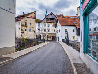 Fototapeta na wymiar Old buildings alongside Capuchin Bridge street in Skofja Loka village, Slovenia
