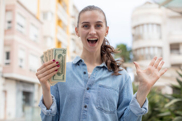 feeling happy and astonished at something unbelievable. dollar banknotes concept