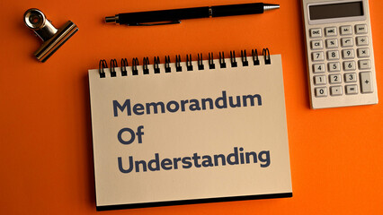 There is notebook with the word Memorandum of Understanding. It is as an eye-catching image.