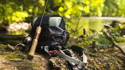 trout spinning and a bag on a log close-up