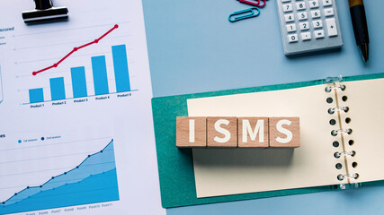 There is wood cube with the word ISMS. It is an abbreviation for Information Security Management System as eye-catching image.