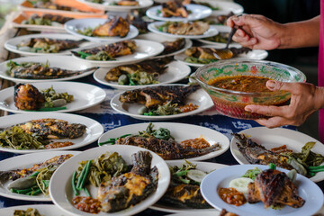 Indonesian food serving grilled chicken, grilled fish and fried catfish