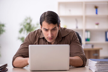 Young attractive employee sitting in the office