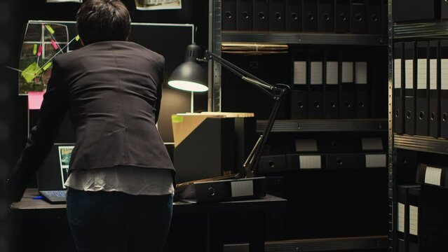 Officer employed to find missing person, private investigator looking at surveillance photos on criminal clues board. Criminologist inspector building case file with forensic expertise.