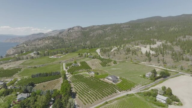 Following the sloped terrain of a coastal property along Okanagan Lake