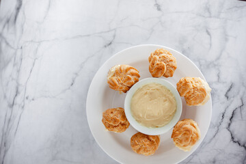 Vanilla Soes Cakes ( Sus Vla ), served in white plate, copy space. White background.