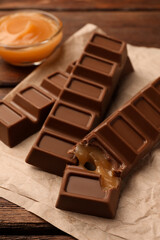 Tasty chocolate bars on wooden table, closeup