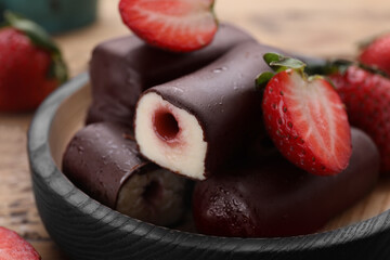 Delicious glazed curd snacks with fresh strawberries and mint on wooden table, closeup