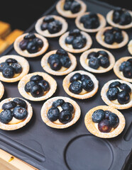 Catering table, beautifully decorated banquet with variety of with different food snacks appetizers on corporate birthday party event or wedding celebration, canape, salad, delicatessen setting