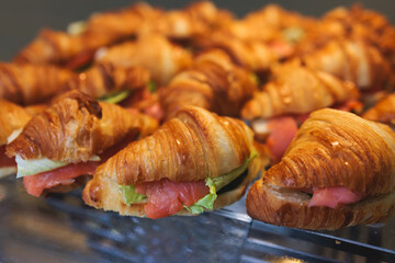 Catering table, beautifully decorated banquet with variety of with different food snacks appetizers on corporate birthday party event or wedding celebration, canape, salad, delicatessen setting