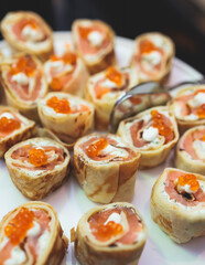 Catering table, beautifully decorated banquet with variety of with different food snacks appetizers on corporate birthday party event or wedding celebration, canape, salad, delicatessen setting