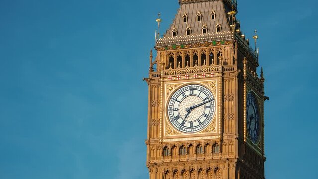 Big Ben clock tower on a sunny early morning in London, UK. A view of the popular London landmark, the clock tower known as Big Ben, showing 3pm as the time set against a blue and cloudy sky.