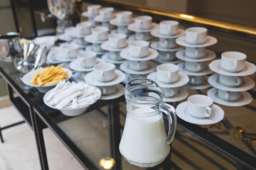 Set of coffee break lunch in the hotel restaurant during conference meeting, with tea and coffee catering, decorated banquet table with white tableware and metal tea maker machine boiler