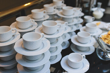 Set of coffee break lunch in the hotel restaurant during conference meeting, with tea and coffee catering, decorated banquet table with white tableware and metal tea maker machine boiler
