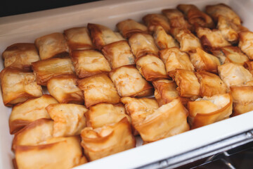 Beautifully decorated catering banquet table with different main course hot food dishes and garnish, with a rice, chicken, salmon fish, lamb, vegetables and kebab on party event wedding celebration