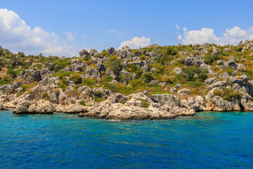 View of the rocky shore from the sea. Mediterranean Sea in Turkey. Popular tourist places. Background