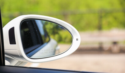 Car side mirror represents reflection, awareness, safety, and the visual extension of the driver's field of view