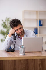 Young male employee working in the office