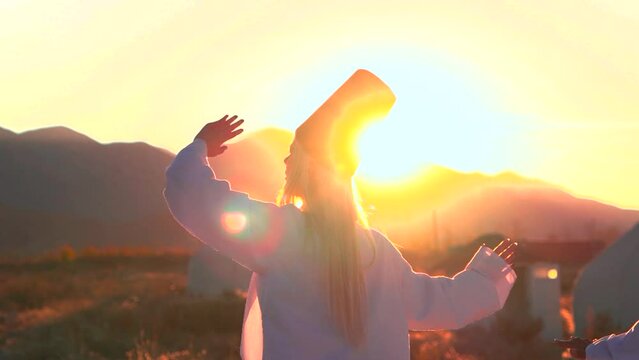 Dervish dance performed against the backdrop of nomads' yurts at sunset