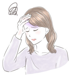 頭を抱えて頭痛に悩む女性