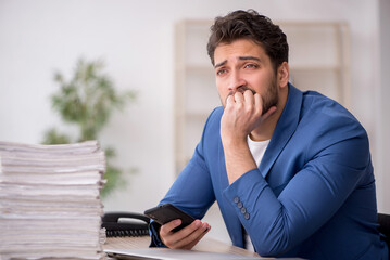 Young male employee working in the office