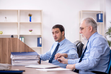 Two male colleagues working in the office