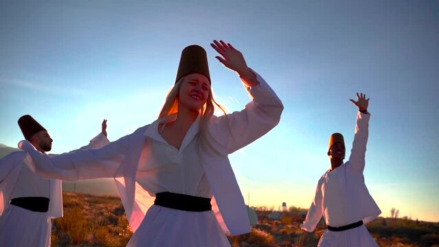 Dervish dance performed against the backdrop of nomads' yurts at sunset