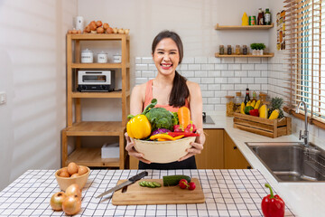 Asian housewife is showing variety of organic vegetables to prepare simple and easy japanese dish to cook salad meal for vegan and vegetarian soul food concept