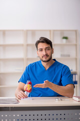 Young male doctor cardiologist working in the clinic