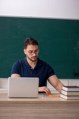 Young male teacher in telestudying concept