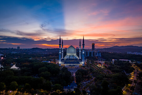 Aerial view of Masjid Sultan Salahuddin Abdul Aziz Shah - The Blue Mosque during sunset. Biggest Mosque in Southeast Asia, Shah Alam, Malaysia. 