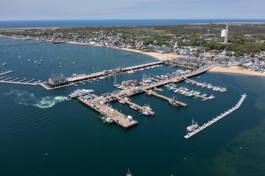 aerial landscape view of MacMillan Pier and Provincetown Marina in front and Provincetown city in the background 