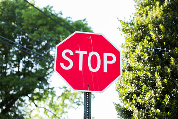 Red stop sign signifies caution, safety, control, and the imperative to pause or halt in order to...