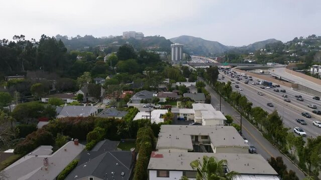Aerial view over a neighborhood near I-405 in cloudy Brentwood, Los Angeles, USA