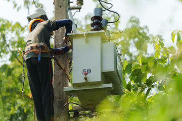 worker install a three-phase current transformer on electric pole